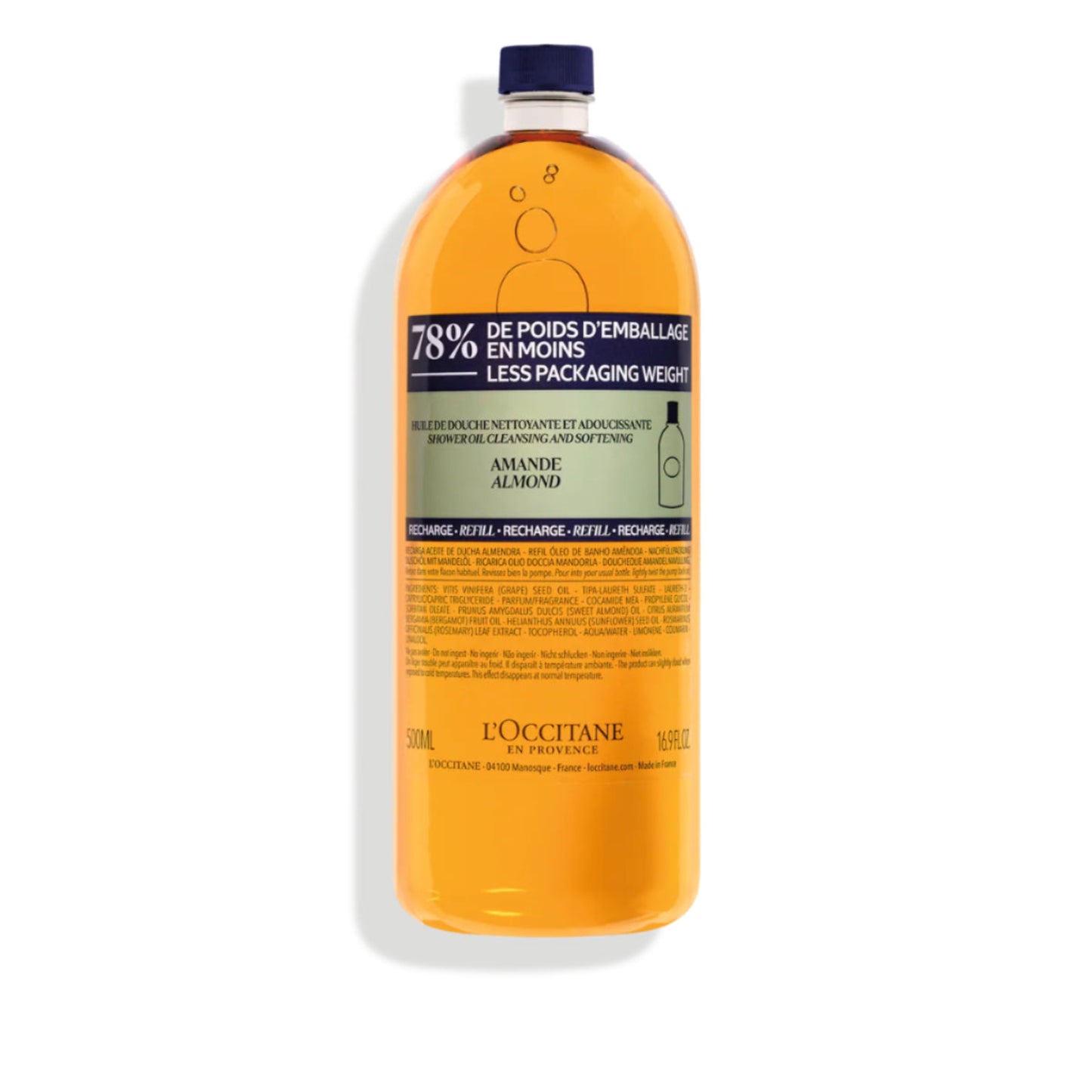 L'Occitane bottle with orange liquid on a white background