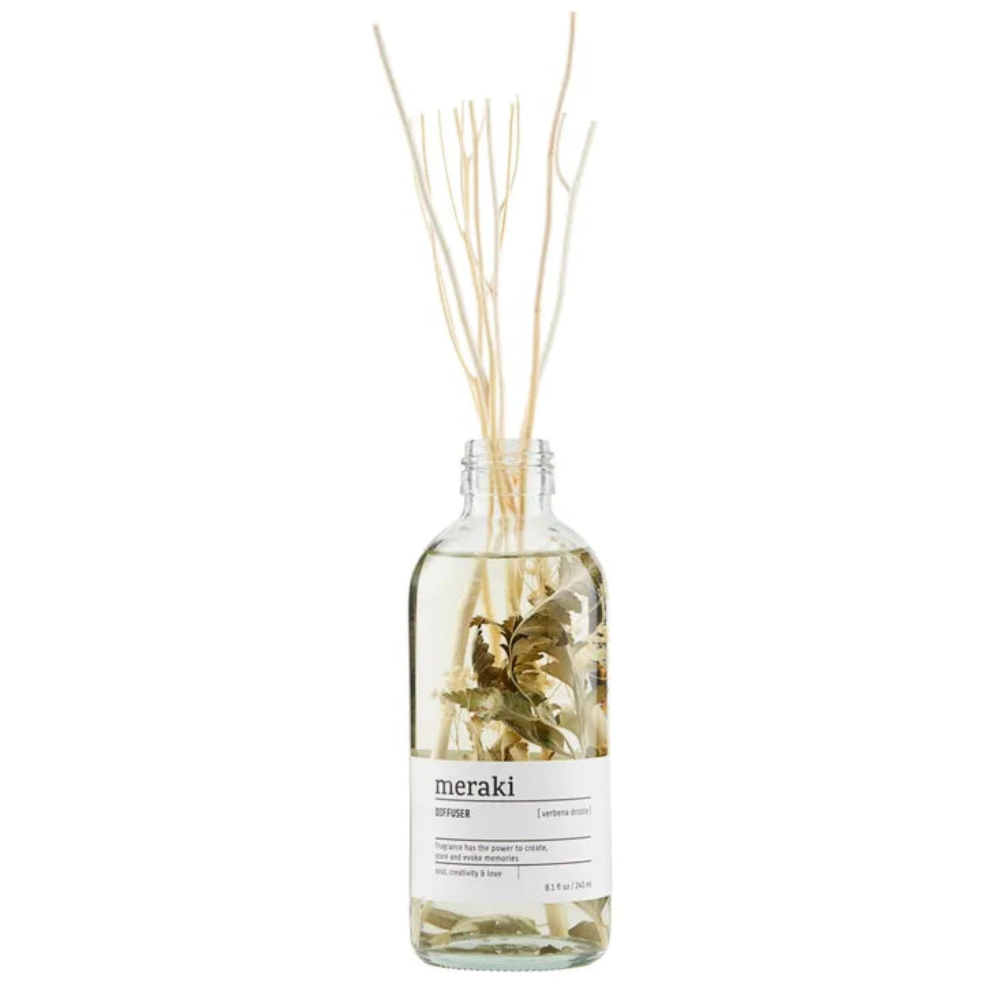 Glass diffuser bottle with reeds and a visible 'meraki' label on a white background